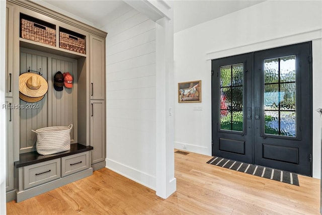 mudroom with french doors and light hardwood / wood-style flooring