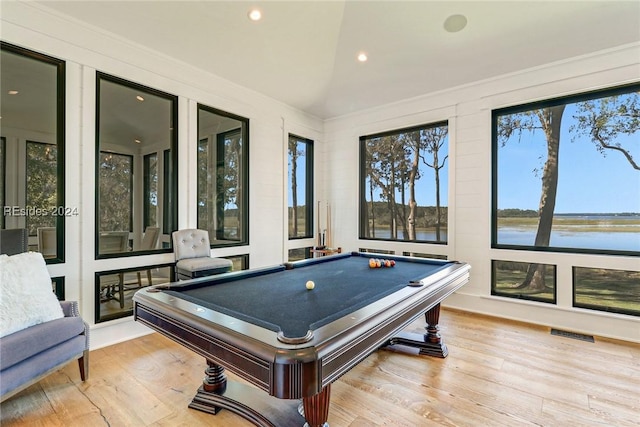 game room featuring a water view, billiards, vaulted ceiling, and light hardwood / wood-style flooring