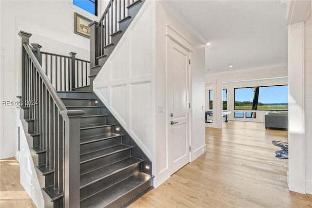 staircase with hardwood / wood-style flooring