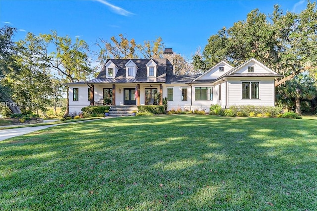 cape cod home featuring a porch and a front yard