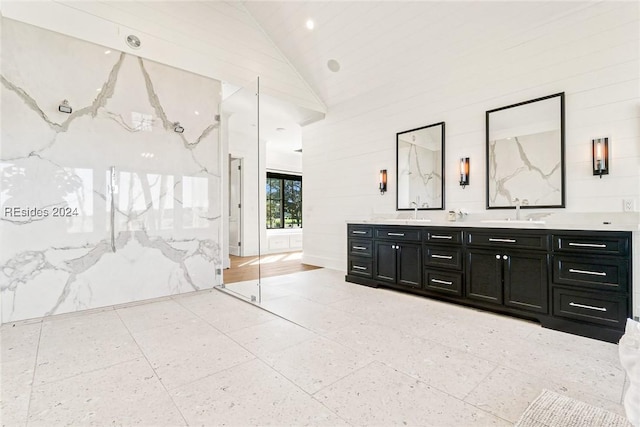 bathroom featuring vanity and high vaulted ceiling