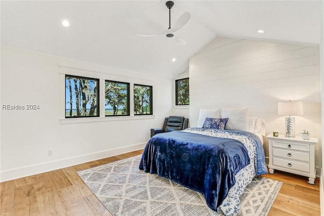 bedroom with ceiling fan, lofted ceiling, and light hardwood / wood-style flooring