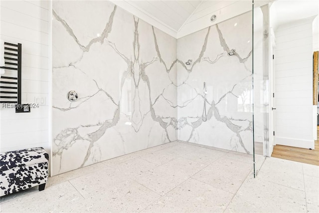 bathroom featuring crown molding, radiator heating unit, vaulted ceiling, and a shower