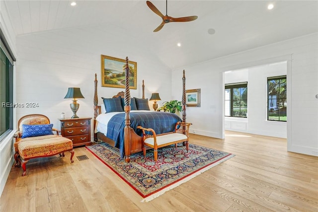 bedroom with ceiling fan, vaulted ceiling, and light wood-type flooring