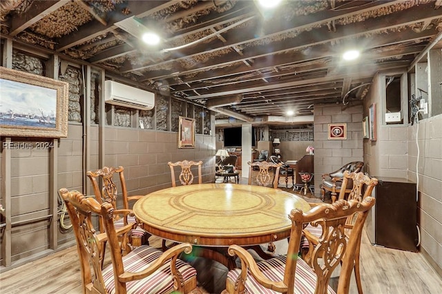 dining room with a wall mounted air conditioner and light wood-type flooring