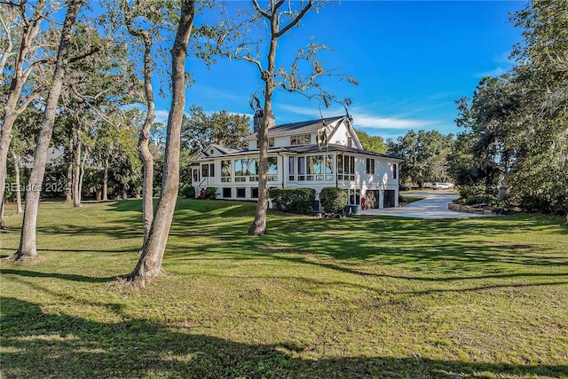 back of property with a lawn and a porch