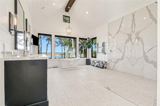 bathroom with beamed ceiling, vanity, a bath, and high vaulted ceiling