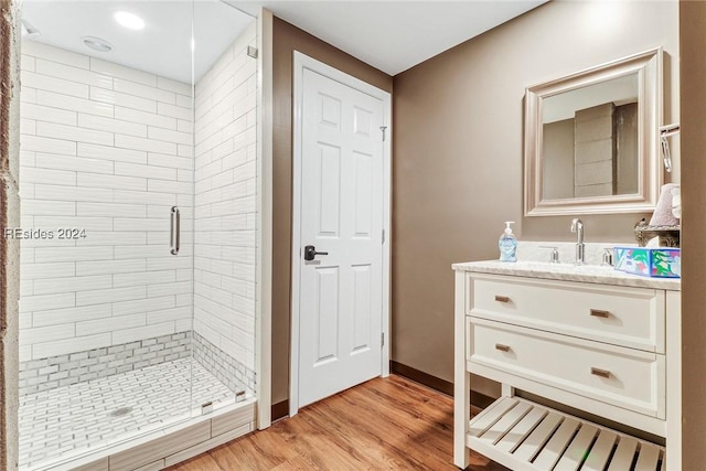 bathroom with vanity, hardwood / wood-style floors, and an enclosed shower