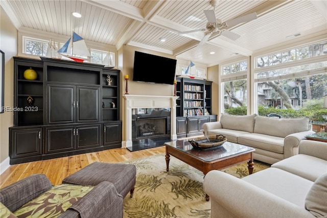 living room with hardwood / wood-style flooring, wood ceiling, beam ceiling, and a premium fireplace