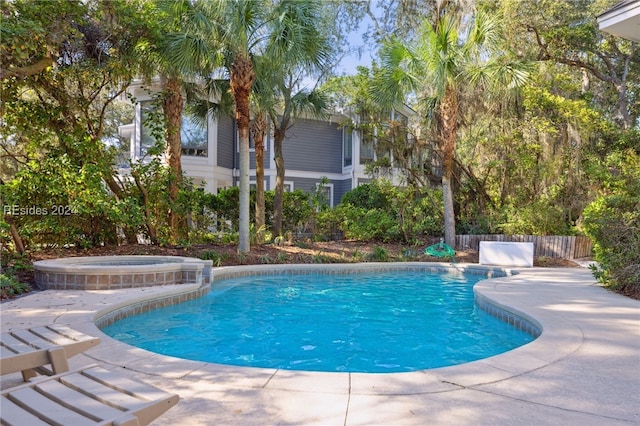 view of swimming pool featuring an in ground hot tub and a patio