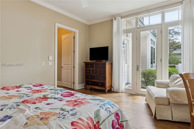 bedroom featuring multiple windows, access to exterior, wood-type flooring, and ceiling fan