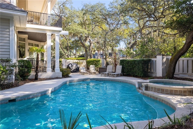 view of pool featuring a patio and an in ground hot tub