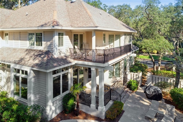 back of house featuring a balcony