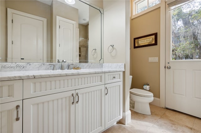 bathroom featuring vanity, tile patterned floors, and toilet