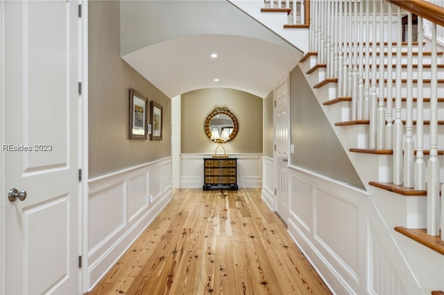 hallway featuring lofted ceiling and light wood-type flooring