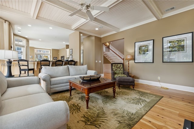 living room with wood ceiling, crown molding, hardwood / wood-style flooring, ceiling fan, and beam ceiling