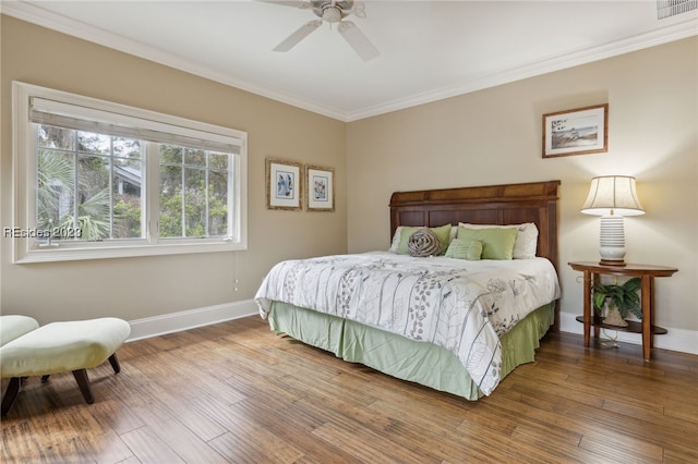 bedroom featuring ceiling fan, ornamental molding, and hardwood / wood-style floors