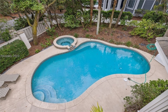 view of pool featuring an in ground hot tub