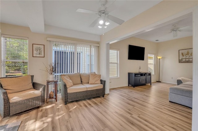 living room with light hardwood / wood-style flooring and ceiling fan