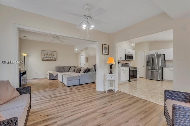 living room with ceiling fan and light hardwood / wood-style floors