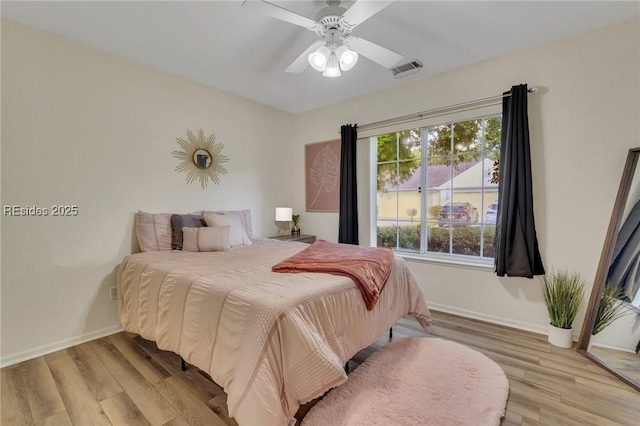 bedroom with ceiling fan and hardwood / wood-style floors