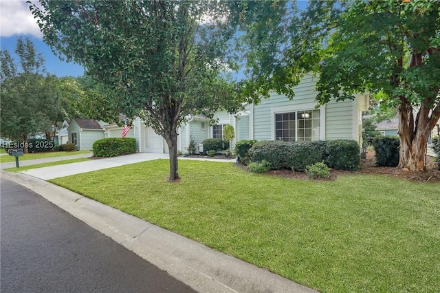 view of front facade with a garage and a front lawn