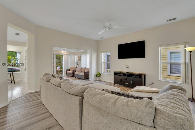 living room featuring light hardwood / wood-style floors and ceiling fan