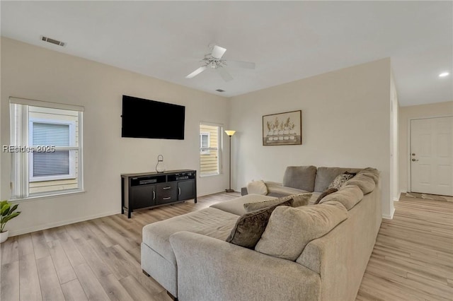 living room with ceiling fan and light hardwood / wood-style flooring