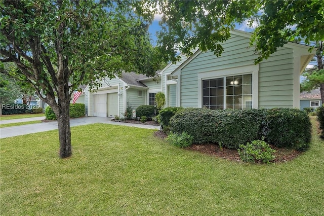 view of front of property with a garage and a front lawn