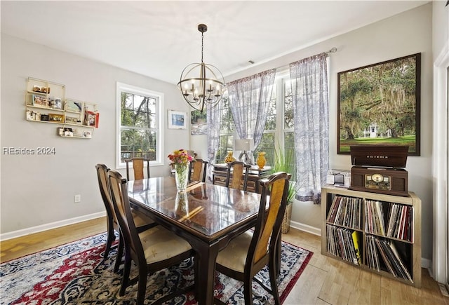 dining area with a chandelier and light hardwood / wood-style flooring