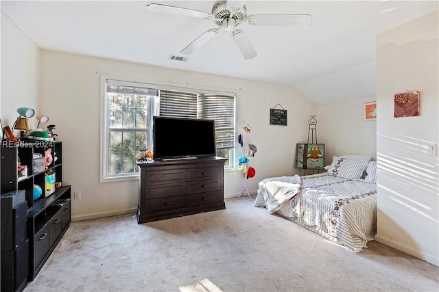 bedroom with vaulted ceiling, light colored carpet, and ceiling fan