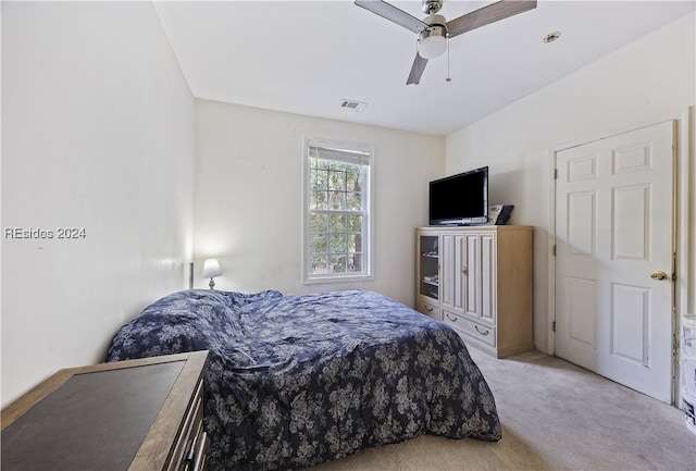 bedroom featuring light carpet and ceiling fan