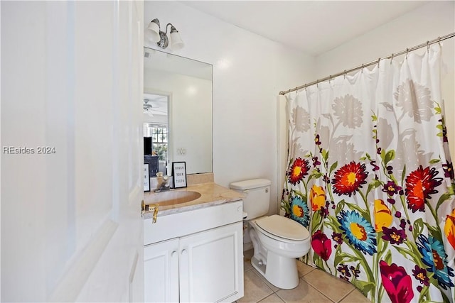 bathroom featuring vanity, tile patterned floors, and toilet