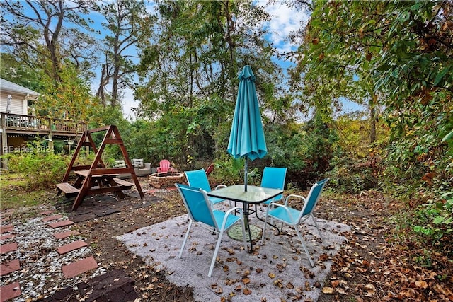 view of patio / terrace featuring a wooden deck and a fire pit