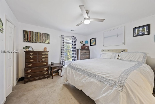 bedroom featuring light carpet and ceiling fan