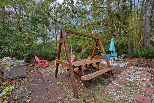 view of playground with a patio area