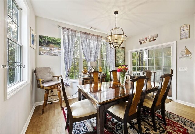 dining room featuring hardwood / wood-style flooring and an inviting chandelier