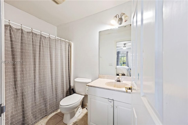 bathroom with walk in shower, vanity, toilet, and tile patterned flooring