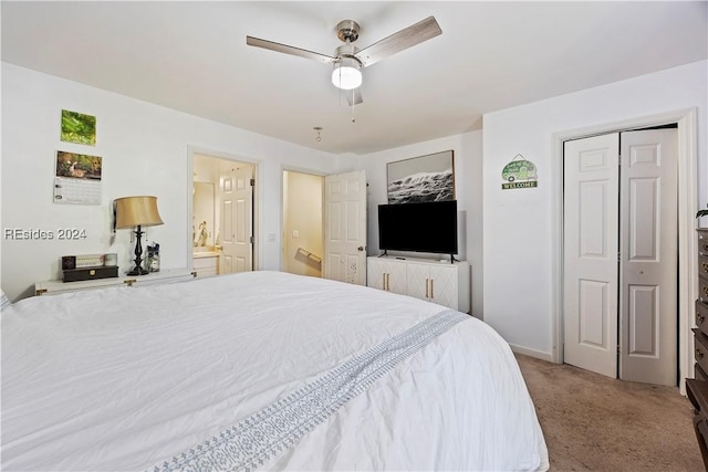 bedroom with ensuite bathroom, carpet, ceiling fan, and a closet