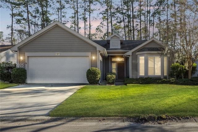 view of front of property featuring a garage and a lawn