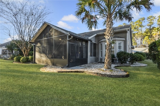 exterior space with a lawn and a sunroom