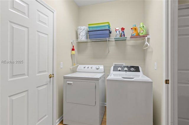 clothes washing area with washer and clothes dryer