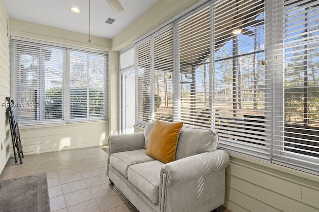 sunroom featuring ceiling fan