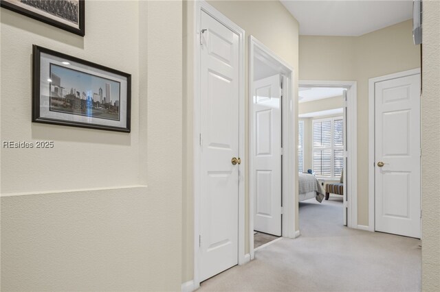 hallway with light colored carpet