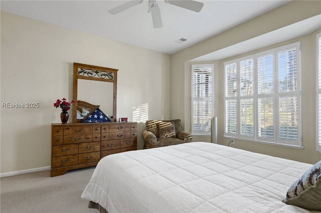 carpeted bedroom with multiple windows and ceiling fan