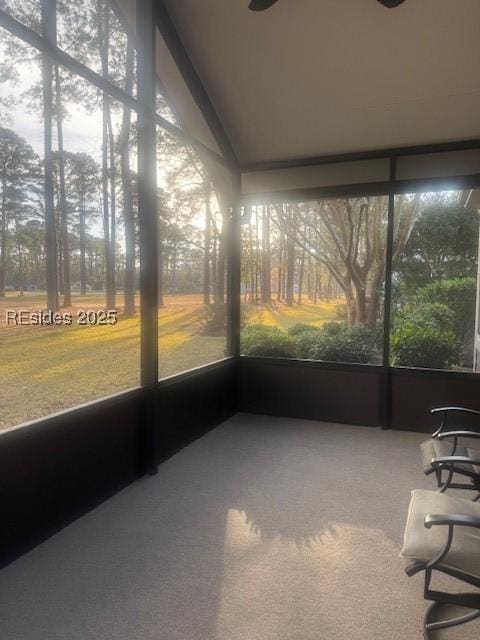 unfurnished sunroom featuring lofted ceiling