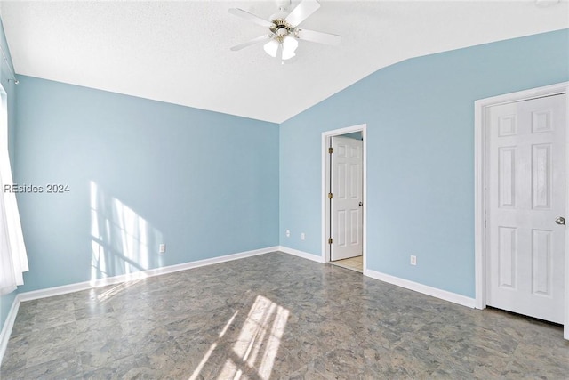 unfurnished bedroom with ceiling fan and lofted ceiling