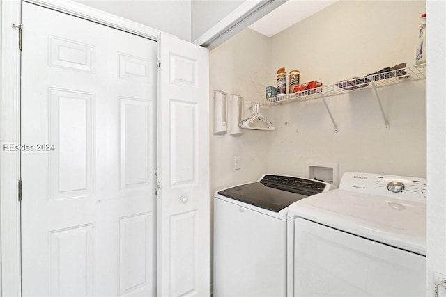 clothes washing area with washer and clothes dryer