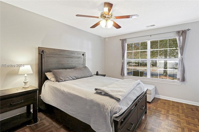 bedroom featuring ceiling fan and dark parquet flooring