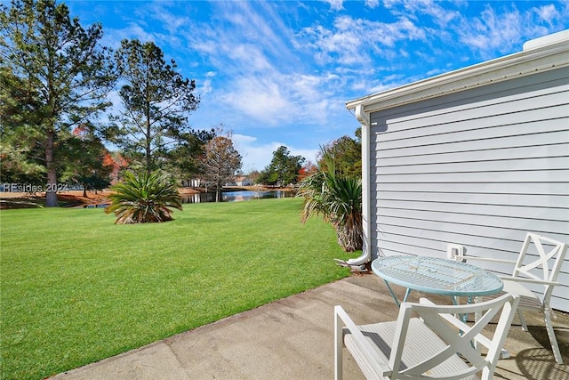 view of yard with a patio and a water view